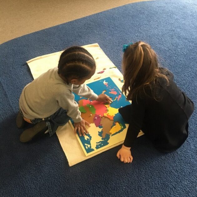 Kids playing together on the floor.